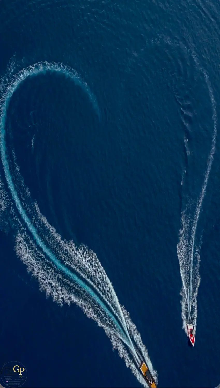 Top-down aerial photograph of two speedboats creating sweeping wakes by GP Creta Productions
