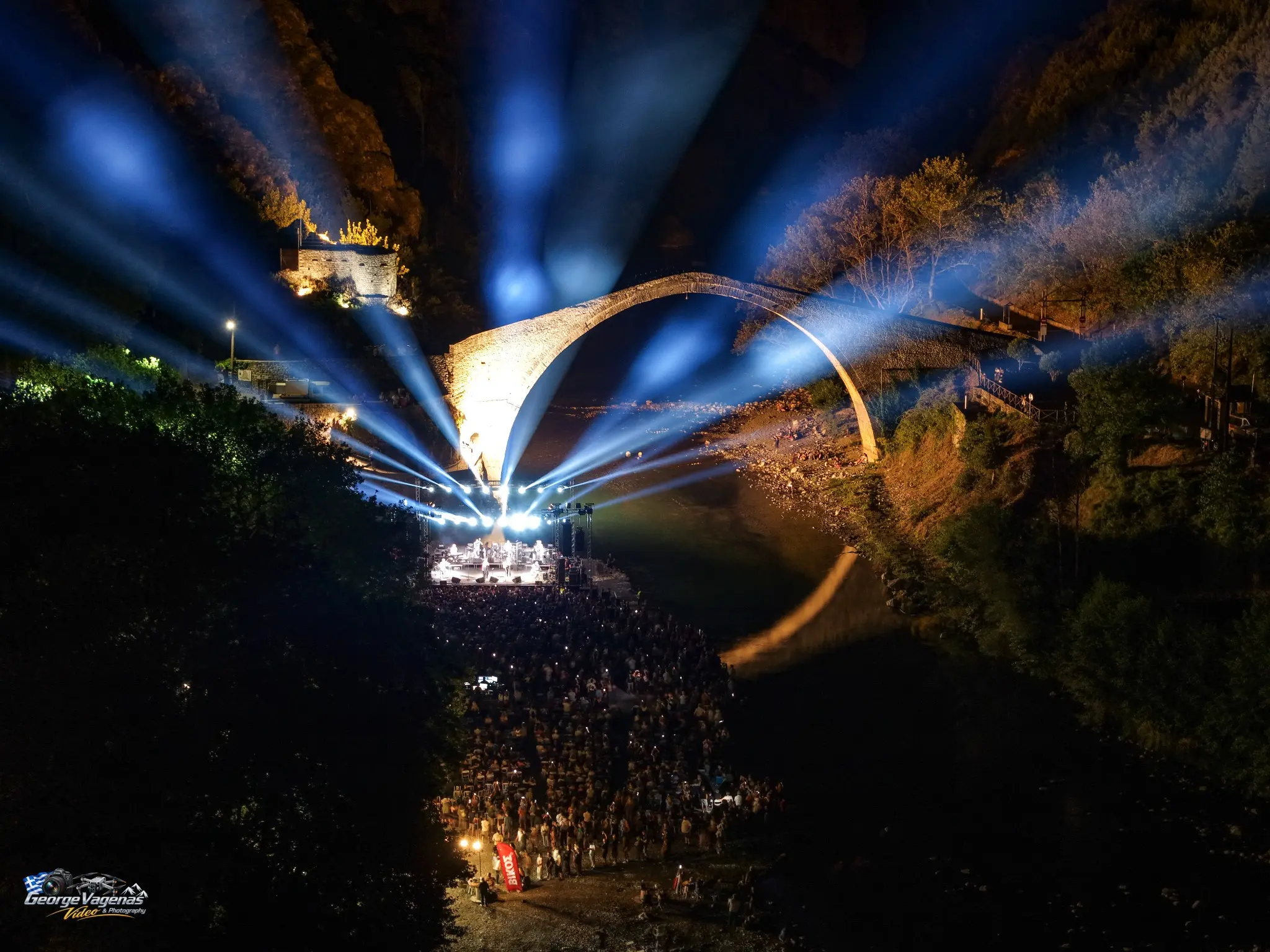 Aerial view of a concert at the Plaka Bridge by George Vagenas