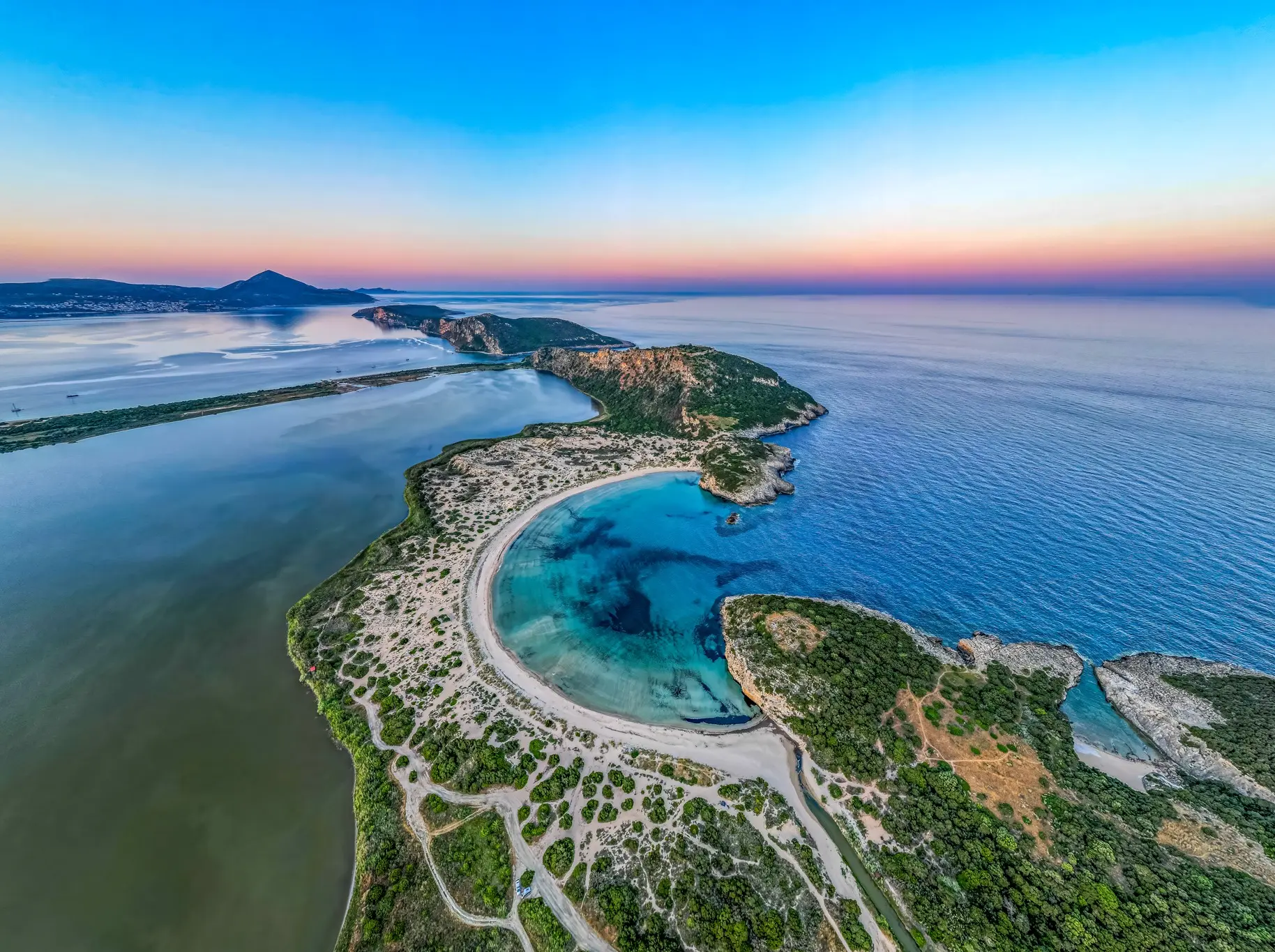Aerial destination photograph of a turquoise lagoon and coastline by Kafetsis A. Fotis