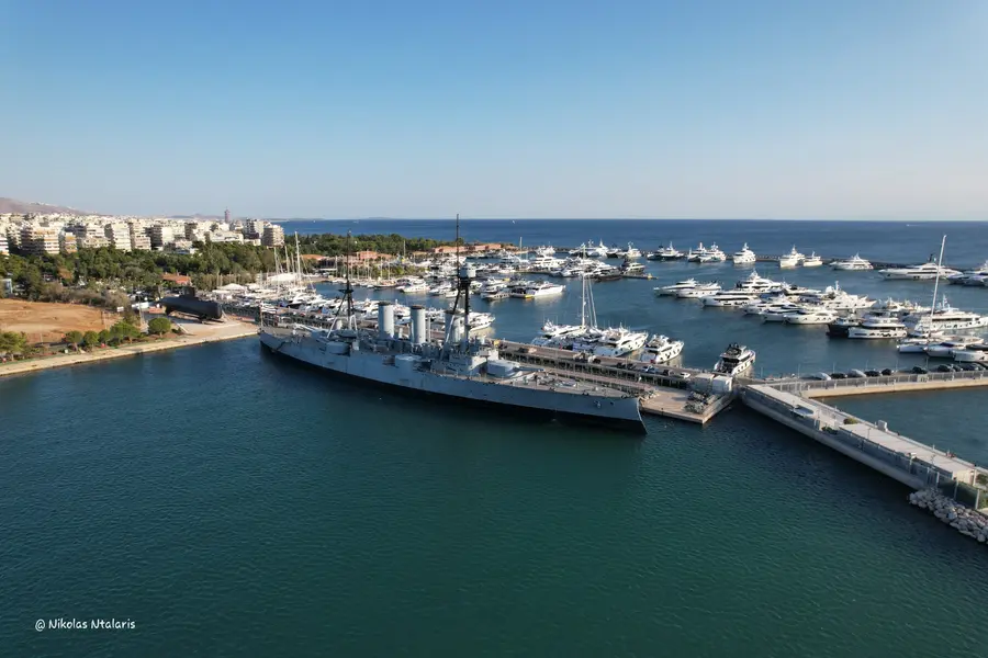 Aerial photograph of a historic naval ship and marina on the Athenian Riviera by Nikolas Ntalaris