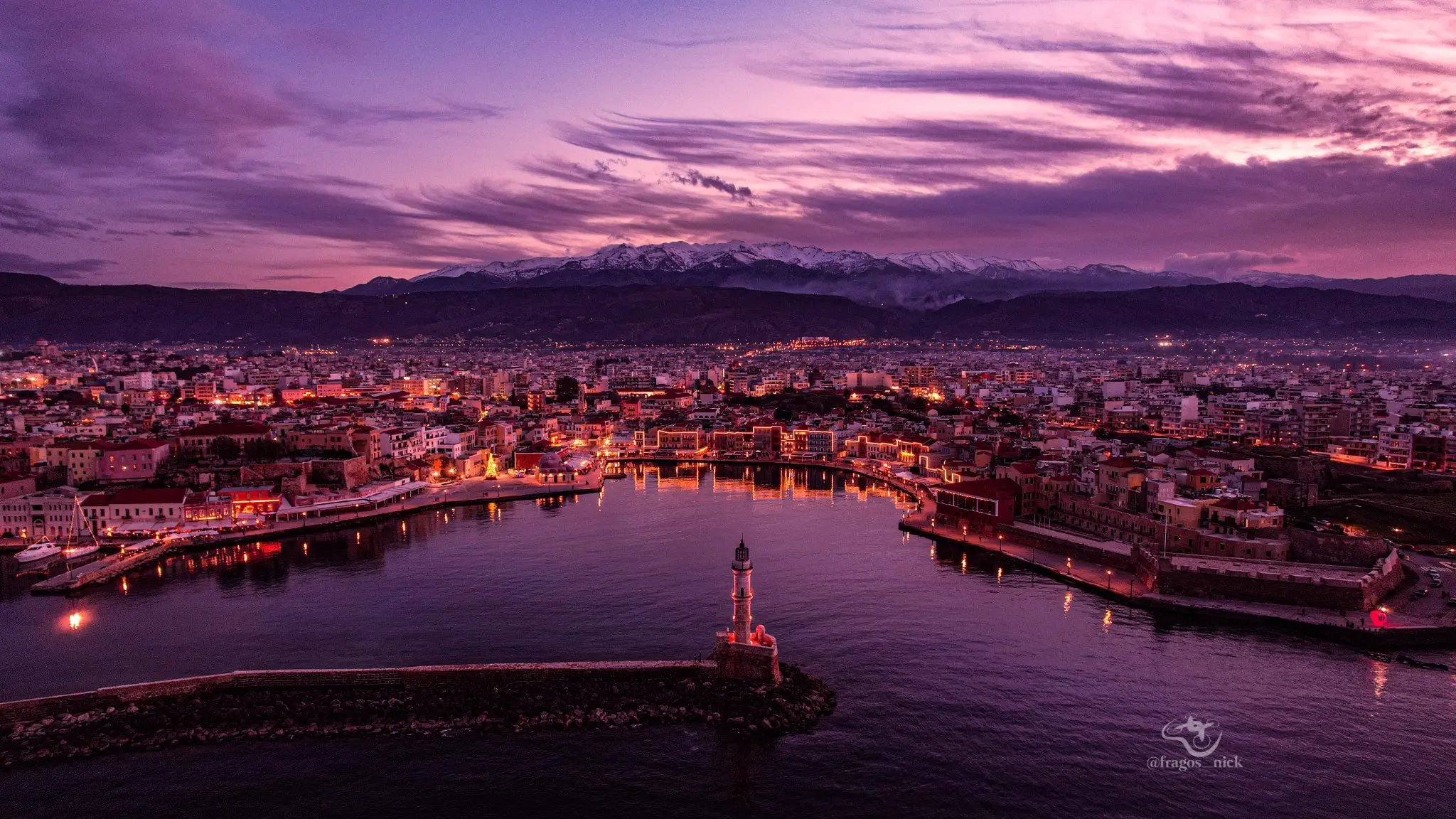 Aerial twilight panorama of Chania harbour and the White Mountains by Nikos Fragos
