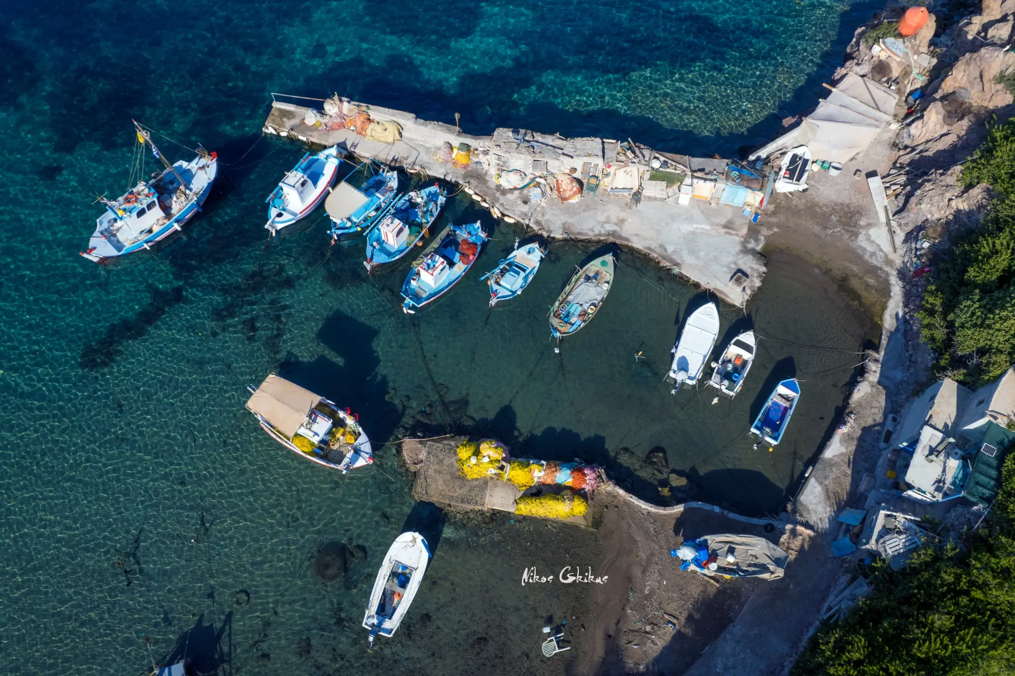 Aerial photograph of a traditional fishing harbour by Nikos Gkikas