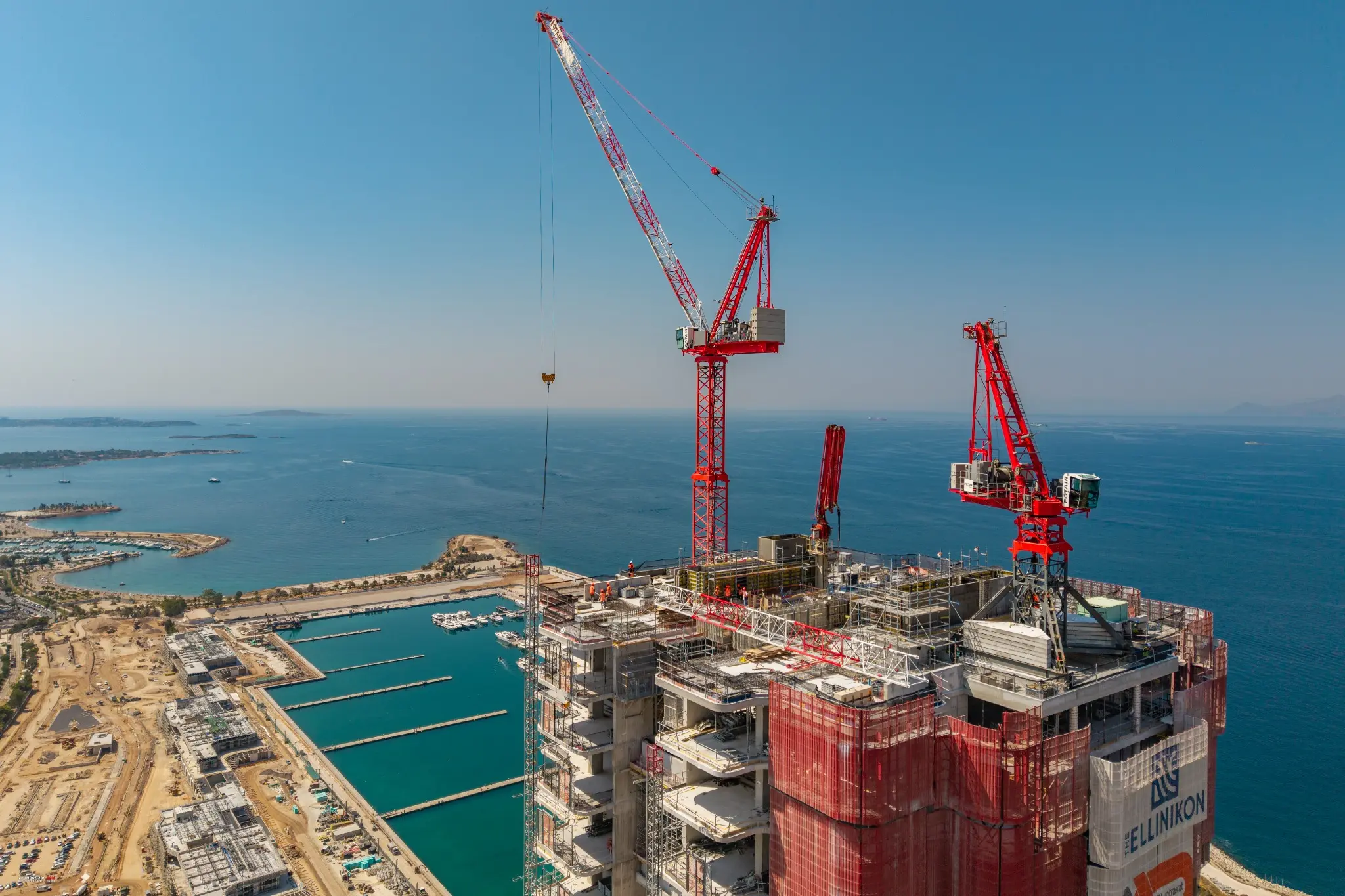 Aerial close-up of tower cranes and construction work at the Ellinikon development by Zisimos Zizos
